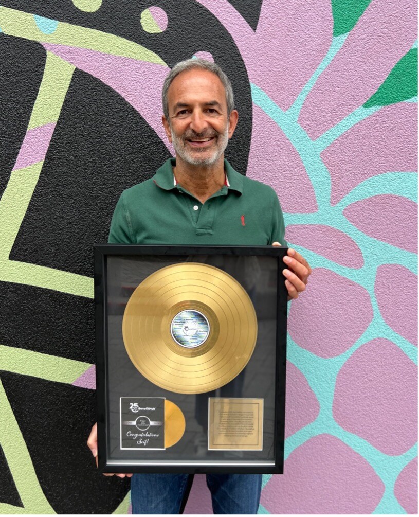Seif Saghri pictured with a platinum record gifted to him to celebrate 25 years of BenefitHub